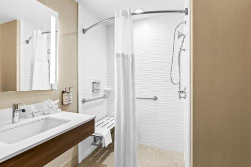 a white bathroom with a shower and a sink at Holiday Inn Express and Suites Hotel - Pauls Valley by IHG in Pauls Valley