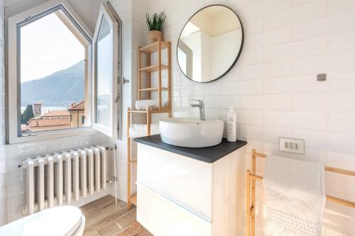a bathroom with a sink and a mirror at Terrace Over Torno - by MyHomeInComo in Torno