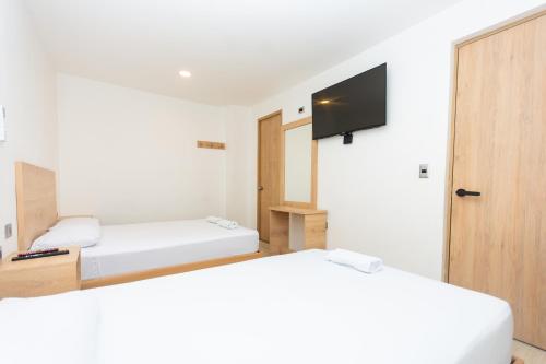 Postel nebo postele na pokoji v ubytování Hotel Villa Real 70 Laureles