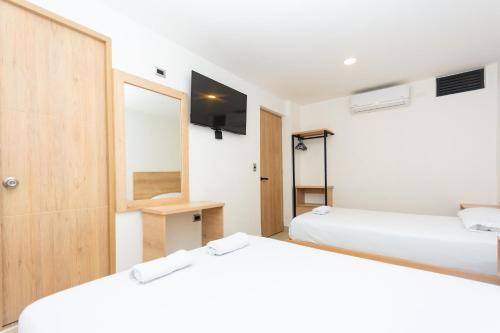 Postel nebo postele na pokoji v ubytování Hotel Villa Real 70 Laureles