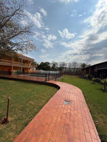 a brick walk way in front of a building at Pousada Maritaca in Bonito