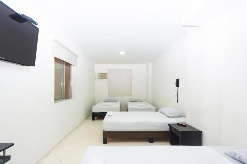 Postel nebo postele na pokoji v ubytování Hotel Villa Real 70 Laureles