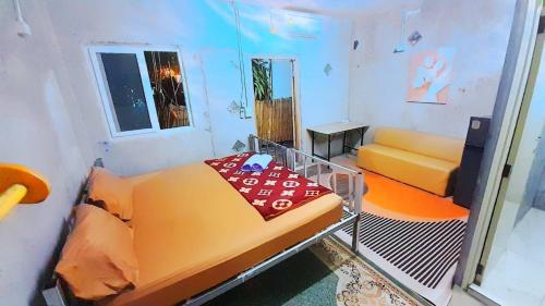 a small room with a bed and a couch at Neena S House in Koh Phangan