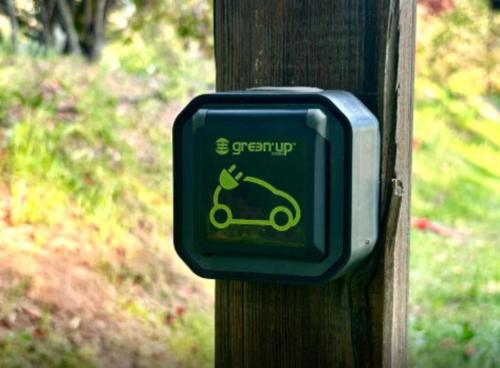 a green sign on a wooden post with a picture of a scooter at Domaine Plan Des Devens Quiétude in Roussillon