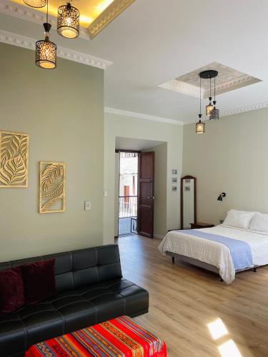 a bedroom with a bed and a couch at TRAVELER'S HOUSE QUITO in Quito