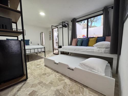 a room with two bunk beds and a tv at The Boat House Suites in Cancún