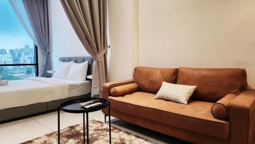 a hotel room with a couch and a bed at Opus Residences Kuala Lumpur by Infini Suites in Kuala Lumpur