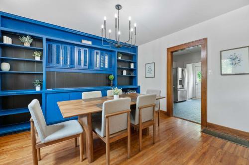 a dining room with blue walls and a wooden table and chairs at 3 Bed 1 5 Bath Home in College Hill By Hospital in Wichita