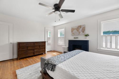 a white bedroom with a bed and a fireplace at 3 Bed 1 5 Bath Home in College Hill By Hospital in Wichita
