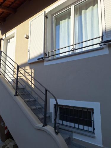 a building with stairs and windows and a balcony at Il Giardino Segreto in Alba