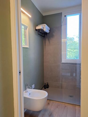a bathroom with a tub and a sink and a shower at Il Giardino Segreto in Alba