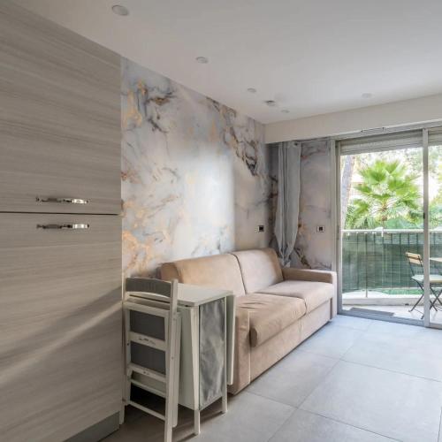 a living room with a couch and a window at Casa Dolce Vita Menton in Menton