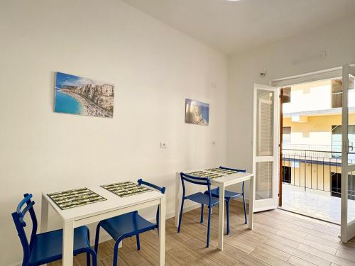 a room with two tables and chairs and a balcony at B&B Salty Mermaid in Tropea
