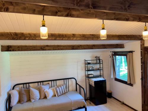 a couch in a room with a wall with lights at Baltic Beach Cozy Tiny House B in Pērkone