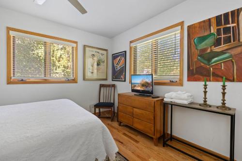 a bedroom with a bed and a desk with a computer at Casa Azur in Union Pier