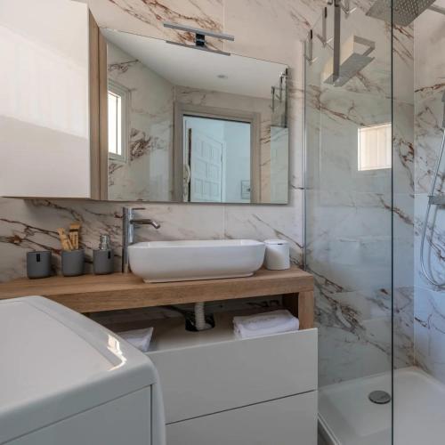 a bathroom with a sink and a mirror at Casa Dolce Vita Menton in Menton
