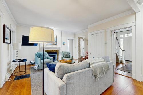 a living room with a couch and a lamp at Norwood Curtis House in Camden