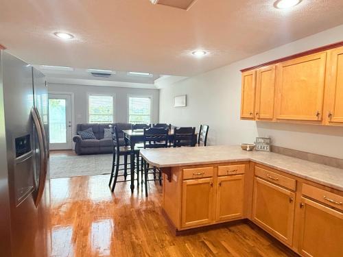 a kitchen and living room with a table and chairs at Lake It Easy 3 Level Home with Hot Tub and Game Space in Somerset