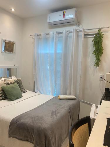 a bedroom with two beds and a window with a heater at Alugo suites mobiliado centro com áreas sociais Picina in Araguaína