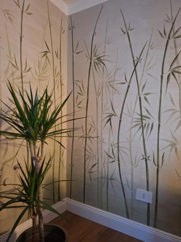a room with a wall with a mural of bamboo at Il Giardino Segreto in Alba