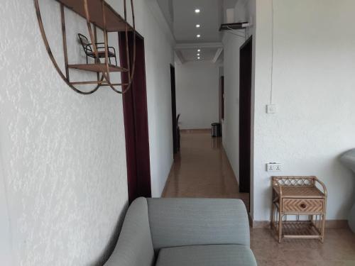 a living room with a couch and a hallway at Le Maho AHAVAH in Trou dʼ Eau Douce