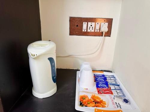 a small bathroom with a toilet and a trash can at Aravind Guest House in Chidambaram