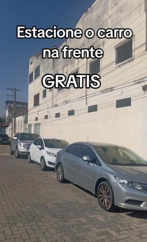 a row of cars parked in front of a building at Suites Aparecida in Aparecida