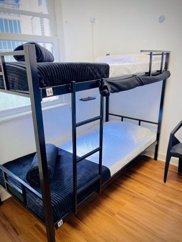a couple of bunk beds in a room at Urban Nomad Hostel and Food Av Paulista in Sao Paulo