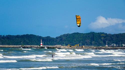 a person kite surfing on the waves in the ocean at ibis budget Navegantes Itajai in Itajaí