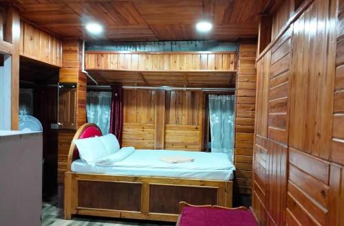 a small room with a bed in a wooden cabin at Ribsweet Treetops Bed and Breakfast in Pynursla