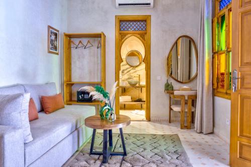 a living room with a couch and a table at Riad AL-Ghazlan Hamam & Spa in Marrakech