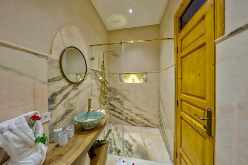 a bathroom with a sink and a mirror at Riad AL-Ghazlan Hamam & Spa in Marrakech