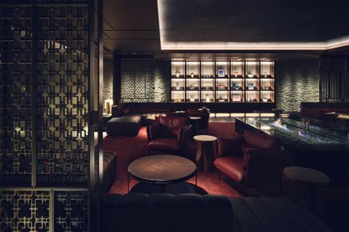 a lobby with a bar with chairs and a table at InterContinental Sapporo by IHG in Sapporo