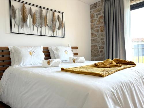 a bedroom with a white bed with a blanket on it at Paços de Douro - Chambre 1 Jardin & Lumière in Romariz