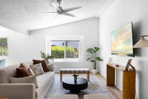 a living room with a couch and a ceiling fan at Stylish Renovation, Perfect for Families & Pets, Garage Parking, Sleeps 10 in Boise