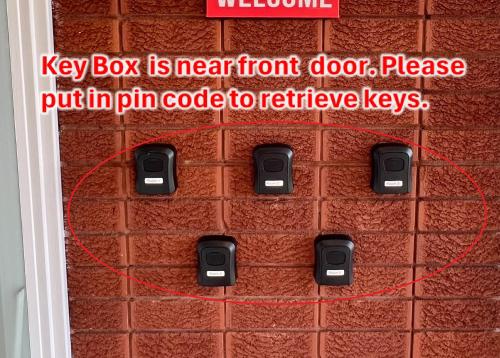 a sign on a wall with a key box is near front door at Cosy Room in North Ryde #2 in Sydney
