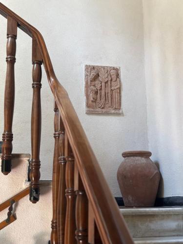 a wooden staircase with a vase on the wall at Le Finestre Veneris in Portovenere