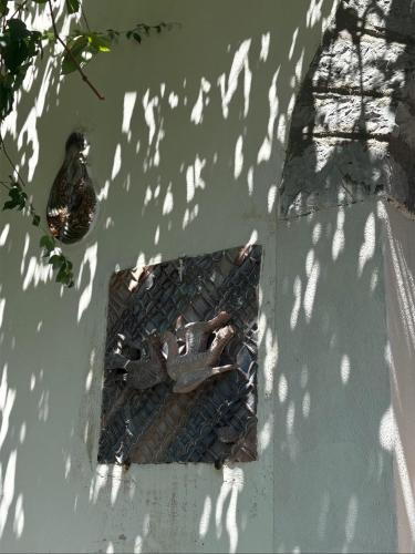 a reflection of a statue of a person in a mirror at Le Finestre Veneris in Portovenere