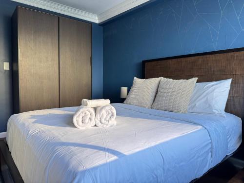 two towels on top of a bed in a bedroom at Atlanta Downtown! High Rise! Onsite Parking Multi Unit in Atlanta