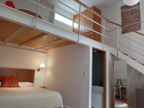 a bedroom with a bunk bed and a staircase at Casa Moctezuma in Mexico City
