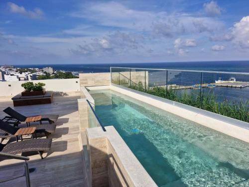 a swimming pool on the roof of a house at Beatiful Loft in Puerto Morelos Beach Front 9-4 in Puerto Morelos
