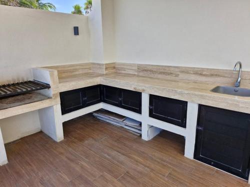 a kitchen with a counter top and a sink at Beatiful Loft in Puerto Morelos Beach Front 9-4 in Puerto Morelos