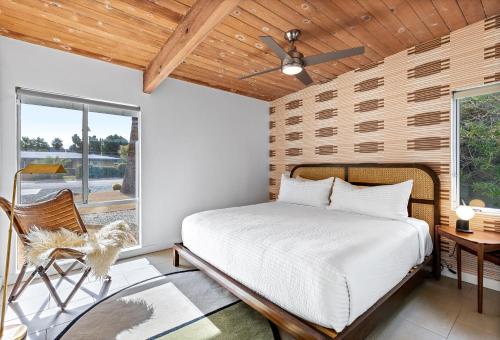 a bedroom with a bed and a window at Mid Century Mood House by ACME House Company in Palm Springs