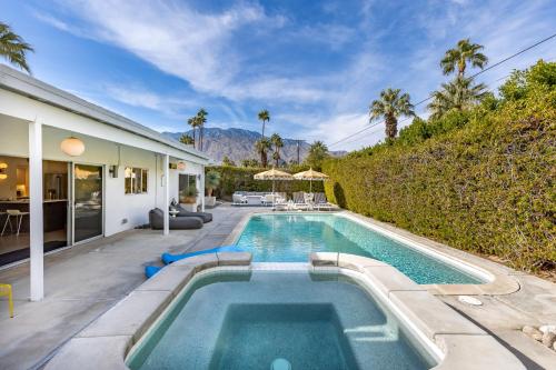 a swimming pool in the backyard of a house at Mid Century Mood House by ACME House Company in Palm Springs