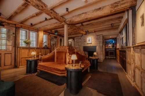 a living room with a couch and a tv at BULL Burford in Burford