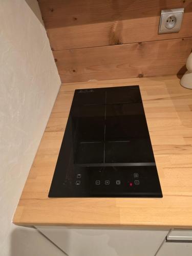 a stove top oven sitting on top of a wooden counter at Appartement 1 chambre in Longevilles-Mont-dʼOr