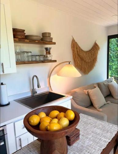 a bowl of oranges in a kitchen with a sink at Zen Container Tiny Home with Fenced-in Yard, Fire Pit, Centrally located and Pet Friendly in Fort Myers