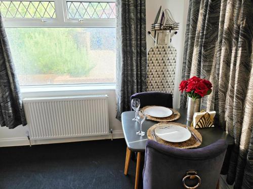 a dining room with a table and chairs and a window at Rose Homestay Brighton - Free parking Ensuite studio room near Brighton Uni in Brighton & Hove