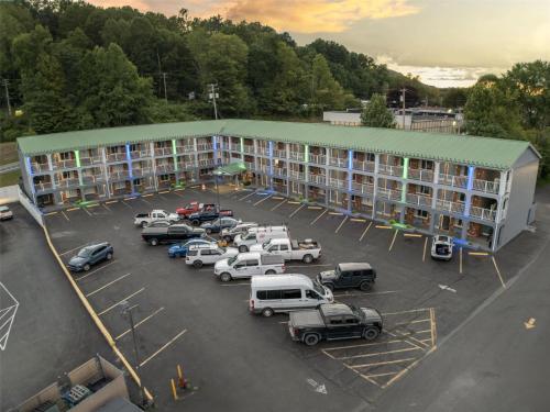 an apartment building with cars parked in a parking lot at SureStay Hotel by Best Western Summersville in Summersville