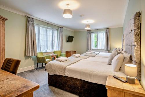 a hotel room with a large bed and a desk at 3 Bed in Cwmtaf oc-p32979 in Merthyr Tydfil